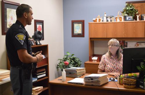 An ISP Officer drops off morning paperwork